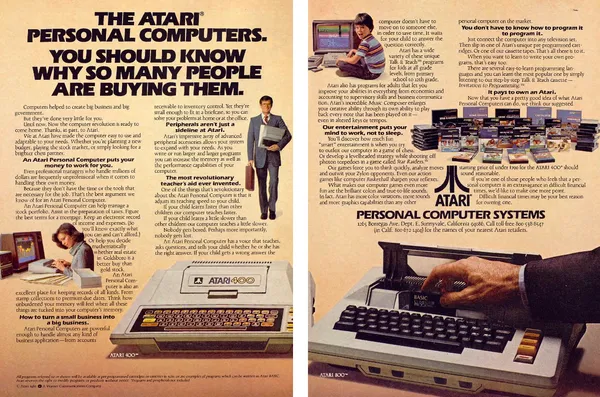 Two-page Atari ad with dense columns of home, school, business and game uses around photographs of Atari 400 and 800 computers.