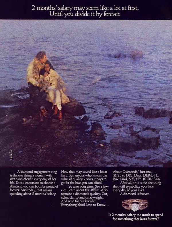 A couple embrace on dark seaside rocks beneath a two-months’ salary headline, with three columns of diamond-buying copy and a gold diamond ring below.