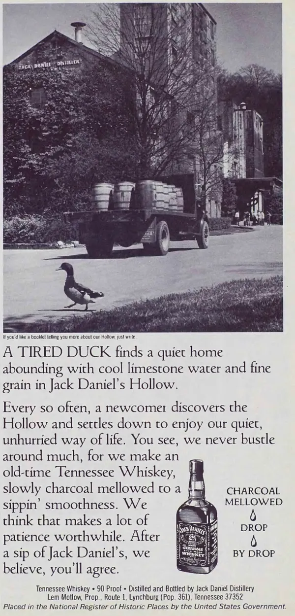 A black-and-white Jack Daniel's advertisement showing a delivery truck leaving the distillery, with a duck crossing the road and a bottle beside the copy.