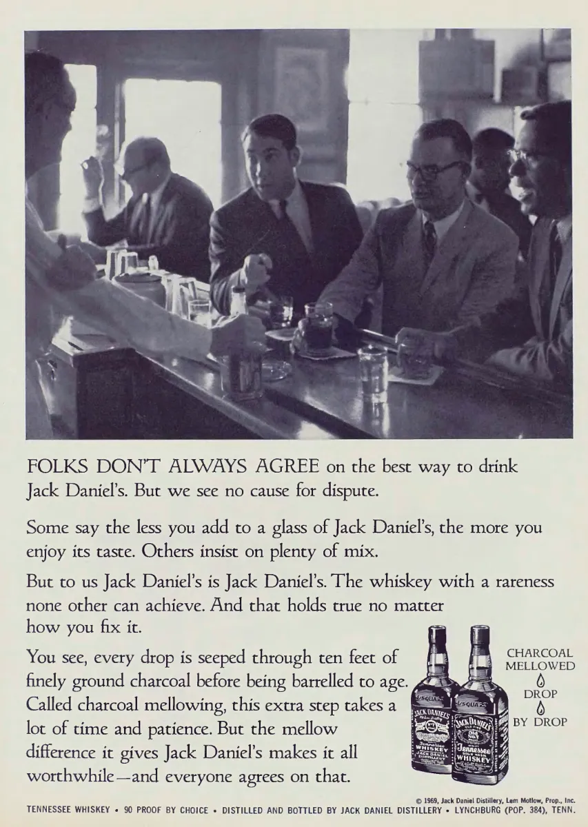 Black-and-white photograph of men at a bar above copy about drinking Jack Daniel's, with two whiskey bottles at lower right.