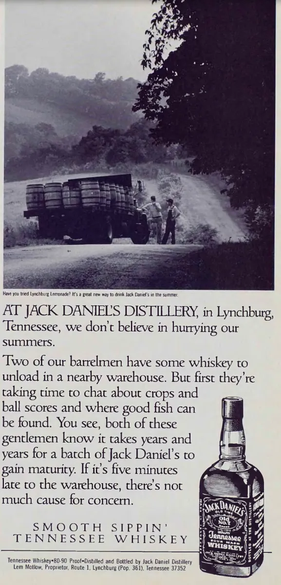 Two barrelmen pause beside a truck loaded with whiskey barrels on a winding rural road, above Jack Daniel's copy and a bottle illustration.