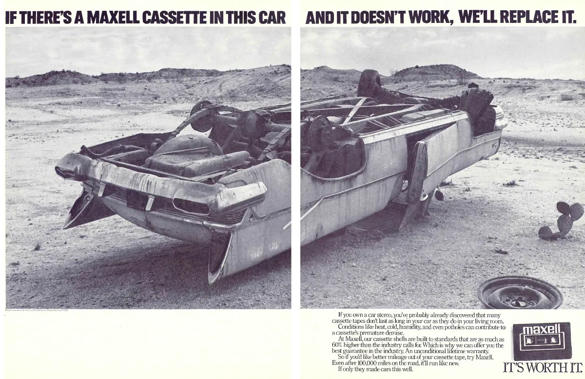 Two-page black-and-white spread shows an overturned wrecked car in a barren landscape beneath a split Maxell cassette warranty headline.
