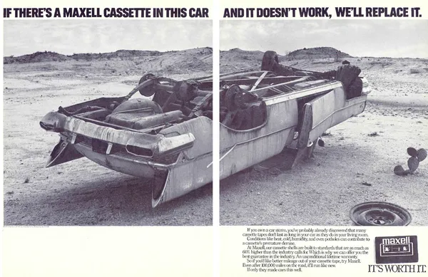 Two-page black-and-white spread shows an overturned wrecked car in a barren landscape beneath a split Maxell cassette warranty headline.
