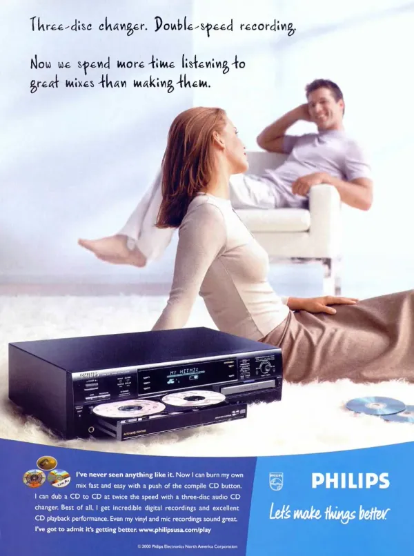 Philips print advertisement from 2001 showing a three-disc audio CD changer in the foreground while a couple relaxes in a bright room.