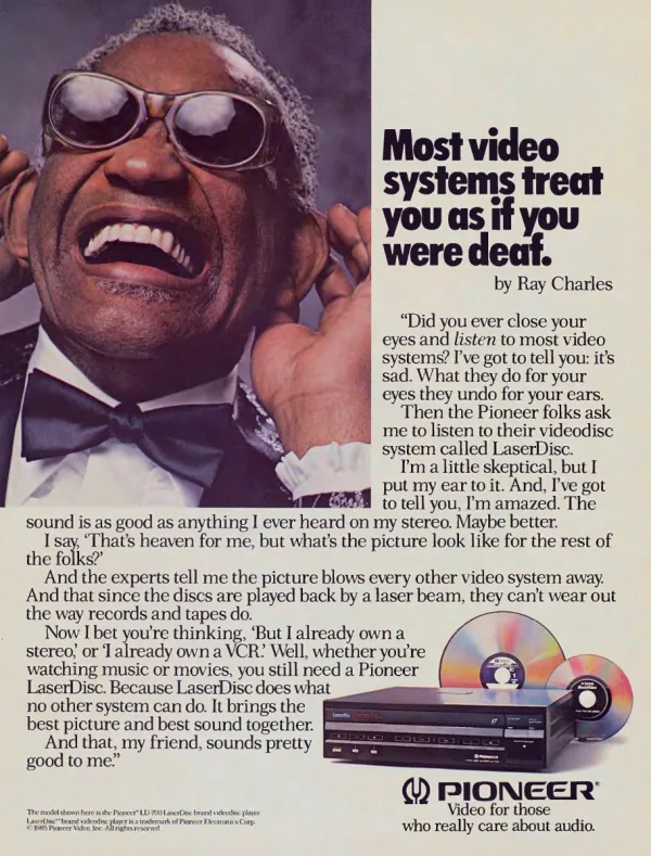 Ray Charles smiles with hands raised beside his ears, next to a testimonial for Pioneer LaserDisc; an LD-700 player and two reflective discs appear below.