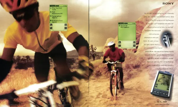 Two-page Sony CLIÉ spread showing a mountain biker close up and on a desert trail, with floating organizer screens and a CLIÉ handheld.