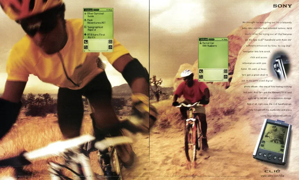 Two-page Sony CLIÉ spread showing a mountain biker close up and on a desert trail, with floating organizer screens and a CLIÉ handheld.