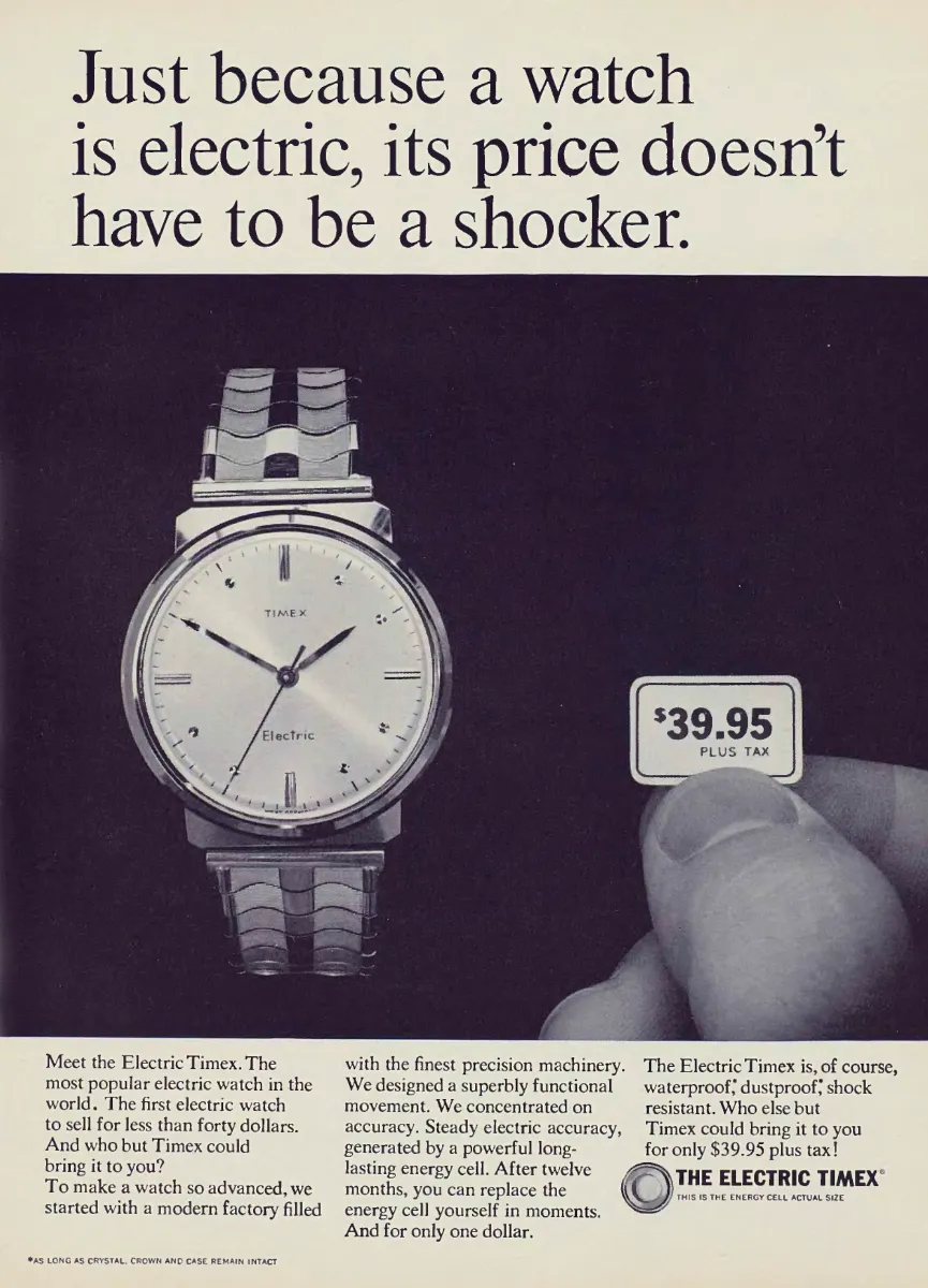 A large Electric Timex wristwatch appears against a dark background beside fingers holding a $39.95 price card.